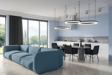 Light kitchen interior with couch and eating area, panoramic window