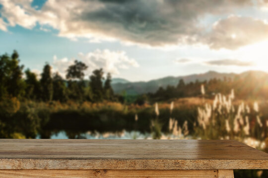 Empty top of wooden shelves on sky mountain and river trees front view background. For product display blur background image, for product display montage..