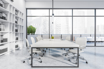 Light office room interior with chairs, table with laptop and panoramic window