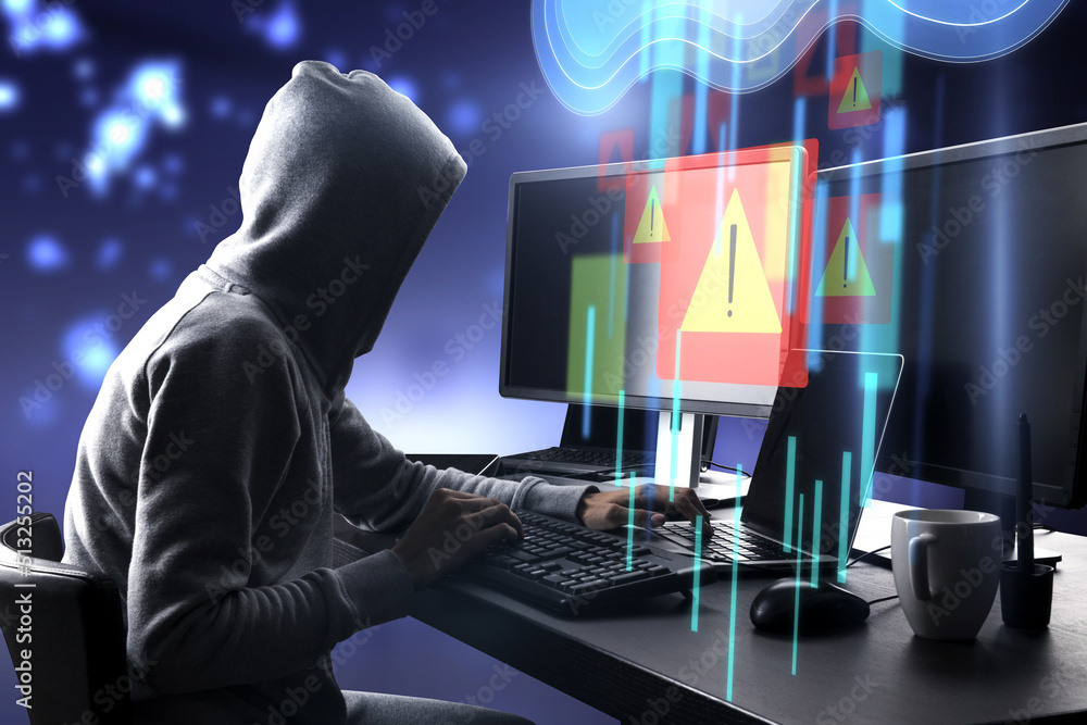 Poster Warning system and cyber attack concept with side view on hacker in hoody working on computers and virtual data cloud network interface with exclamation point