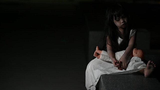 sad child ghost at night,Halloween  Festival concept,Friday 13th,Horror movie scene,A girl with doll