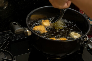 frying dough in oil, for a typical Brazilian recipe called 'bolinho de chuva'