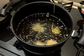frying dough in oil, for a typical Brazilian recipe called 'bolinho de chuva'