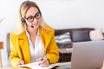 Woman customer support call center operator or receptionist in headset consulting client using...
