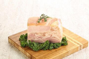 Cut of pork bacon over board