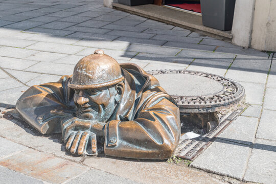 Bratislava, Slovakia - May 31, 2022: Cumil man at work statue in old town of Bratislava.