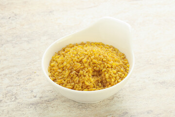 Raw bulgur in the bowl