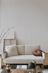 Elegant Scandinavian hygge style home living room interior: comfortable sofa, pillow, white walls, home plants. Aesthetic luxury bright apartment interior design concept © Floral Deco