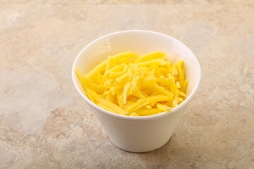 Shredded yellow cheese in the bowl