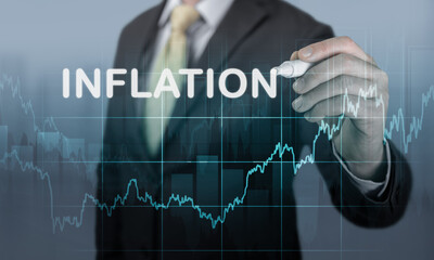 businessman writes word inflation against background of graph of rising inflation rates 2023 2022 years. Inflation, hyperinflation, dollar stagflation