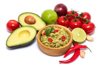 Wooden bowl of guacamole dip sauce and ingredients isolated on white background
