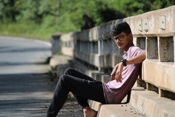 person sitting on a bridge 