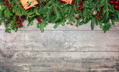rustic wooden background with christmas ornaments. Christmas Holiday Evergreen Pine Branches and Red Berries Over Wood Background, Copy Space. Christmas rustic mockup
