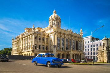 street view of havana with vintage car in cuba - obrazy, fototapety, plakaty