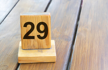 Wooden priority number 29 on a plank tab