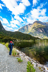 Fototapeta na wymiar Woman taking pictures of the fjord