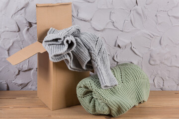 Fototapeta na wymiar wool sweaters packed in a cardboard box to be sent to the customer, the concept