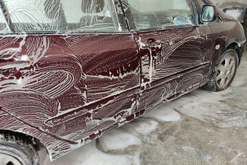 car in the foam at the car wash close-up