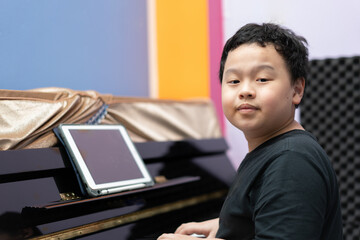 boy with piano look at camera