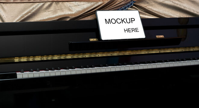 tablet computer on piano for online learning - Powered by Adobe