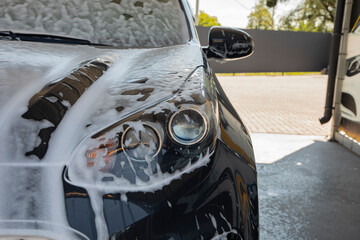 Black car being washed at a car wash