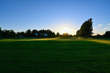 Fototapeta premium evening light over golf course in Kumla Sweden