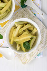 Homemade Manisan or Asinan Mangga is Candied Young Mango Pickles, Thin Sliced Mix with Water and Sugar