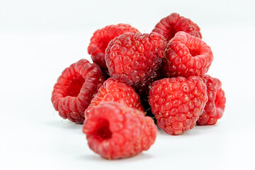 Fresh Raspberries isolated in white background, detailed texture, studio lighting, negative space