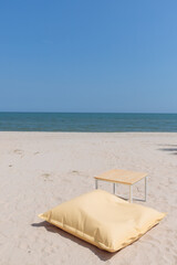 Lounge chair and small table on the beach