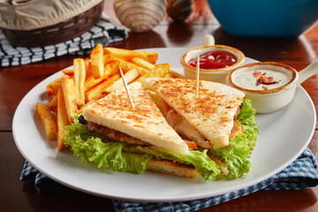 Smoke Chicken sandwich with fries, ketchup, mayo dip sauce served in a dish isolated on wooden background side view