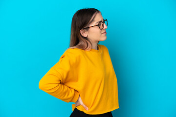 Young caucasian woman isolated on blue background suffering from backache for having made an effort