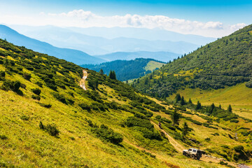 yasinya, ukraine - AUG 22, 2020: 4x4 running on the mountain road in carpathians. beautiful summer landscape. view in to the distant valley. sunny morning weather