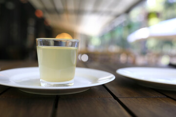 Glass of moonshine on white plate