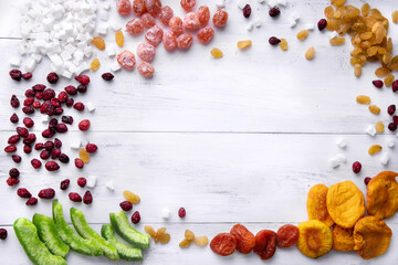 flat lay different dried fruits on the white wooden table place for the tex