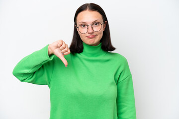 Young caucasian woman isolated on white background showing thumb down with negative expression