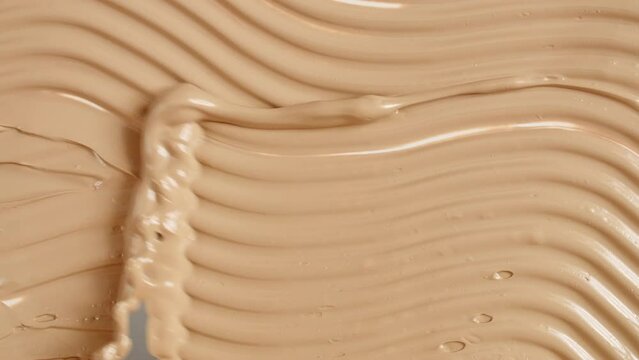 Foundation for face, smear, concealer, cosmetic liquid foundation, make-up smudge or cream beige color smudge, makeup brush. Beauty skincare product sample. Macro Shot. High quality 4k footage
