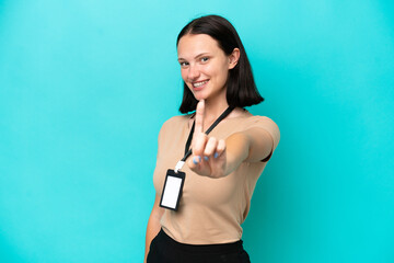 Fototapeta na wymiar Young caucasian woman with ID card isolated on blue background showing and lifting a finger