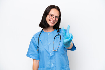 Young nurse caucasian woman isolated on white background smiling and showing victory sign