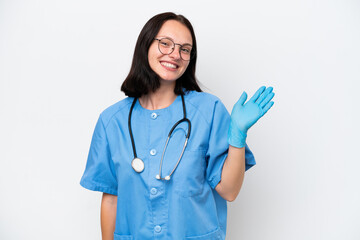 Young nurse caucasian woman isolated on white background saluting with hand with happy expression