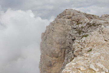 Mountain massif with dense fog on background, Dolomites, Italian Alps.