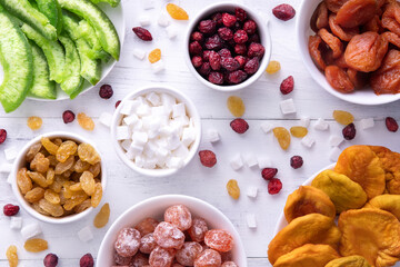 flat lay different dried fruits on the white wooden table,