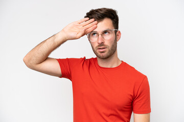 Fototapeta premium Young caucasian man isolated on white background With glasses and tired