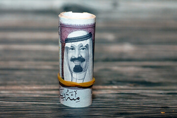 100 SAR one hundred Saudi riyals cash money banknote bills rolled up with rubber bands with the...