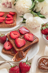 French toast with fresh red strawberries and chocolate cream.