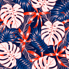 Abstract seamless tropical pattern with bright plants and leaves on a dark blue background. Exotic wallpaper. Colorful stylish floral. Tropic leaves in bright colors.