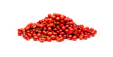 Pink peppercorns, spice close-up flat lay on a white background. Indian and Arabic spices for cooking. Medicinal herbs and spices.