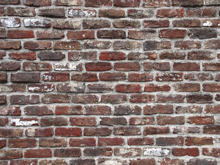 Fototapeta premium でこぼこで赤いレンガの壁面
