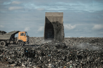 Recycling concrete and construction waste from demolition. Excavator at landfill of the disposa....