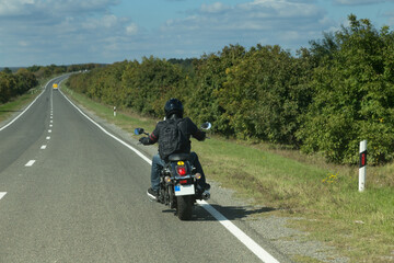 Back view of biker in a road.
