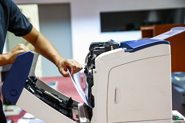 Technician hand open cover photocopier or photocopy to fix paper jam and replace ink cartridges for...